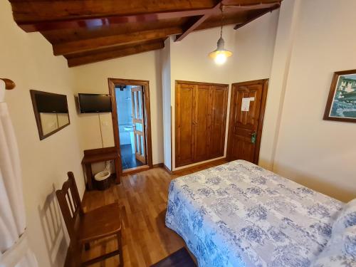 a bedroom with a bed and a wooden floor at Hotel La Balsa in Cangas de Onís