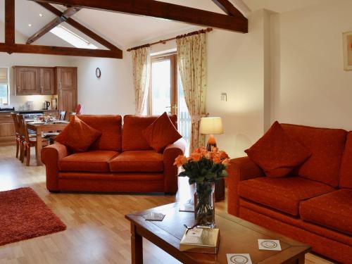 a living room with two couches and a table at Greengage in Lissett