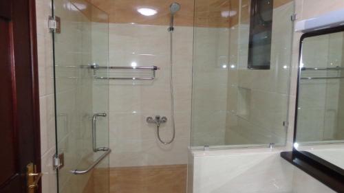 a bathroom with a shower with a glass door at Eagle Palace Hotel in Nakuru