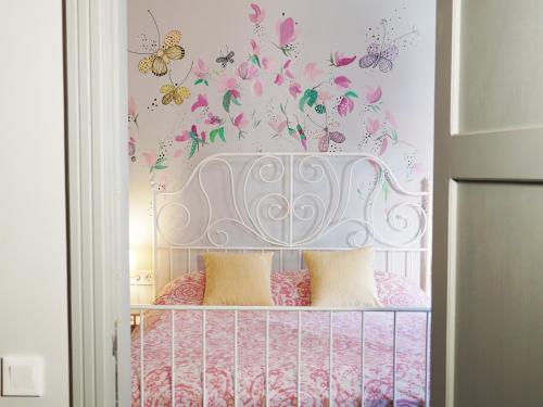 a bedroom with a crib with butterflies on the wall at Tilas - Rooms in 19th Century Wooden Townhouse,Kadikoy in Istanbul