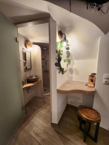 a bathroom with a sink and a stool in a room at Myrto's Luxury Rooms in Areopolis