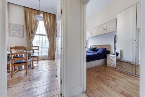 a bedroom with a bed and a dining room at Apartment in Baker Street- Huge Balcony in London
