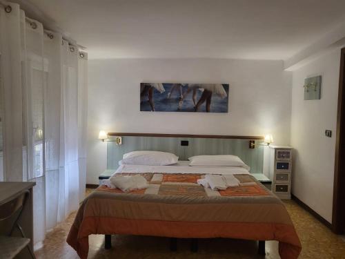 a bedroom with a bed with two towels on it at Villa rosa in Loano