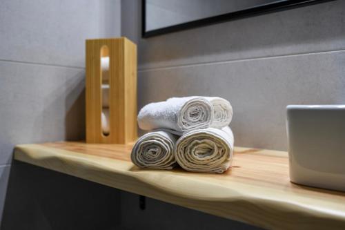 a pile of towels on a table with a laptop at Casa De Lago in Agios Nikolaos