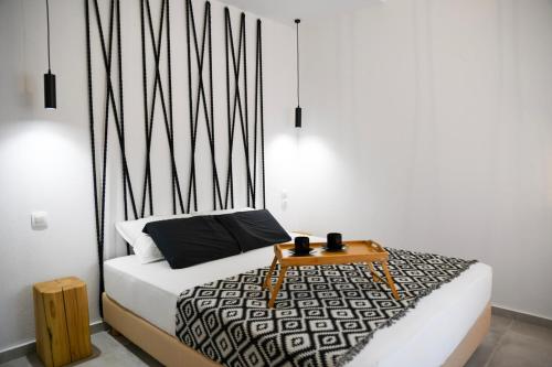 a bedroom with a bed with a table on it at Casa De Lago in Agios Nikolaos