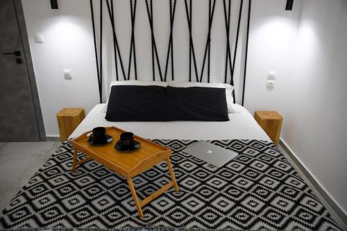 a bed with a table with a laptop on it at Casa De Lago in Agios Nikolaos