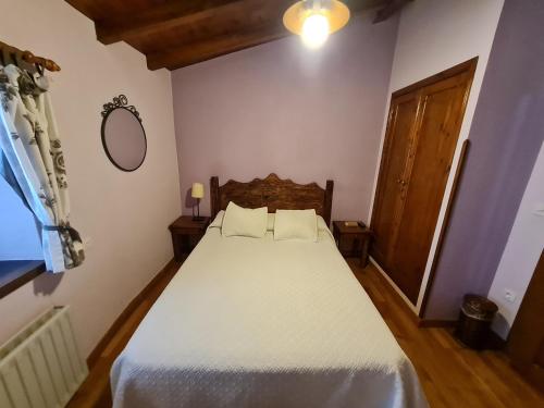 a bedroom with a large white bed in a room at Hotel La Balsa in Cangas de Onís