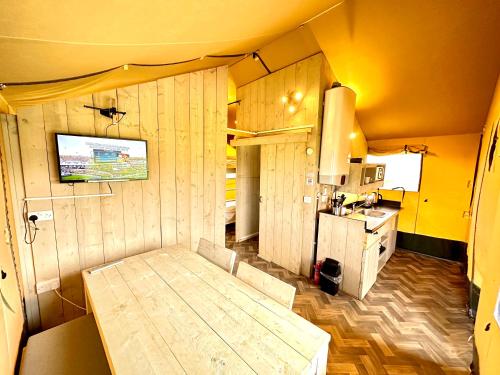 a small room with a bed and a kitchen at Little Pig Glamping in Bude