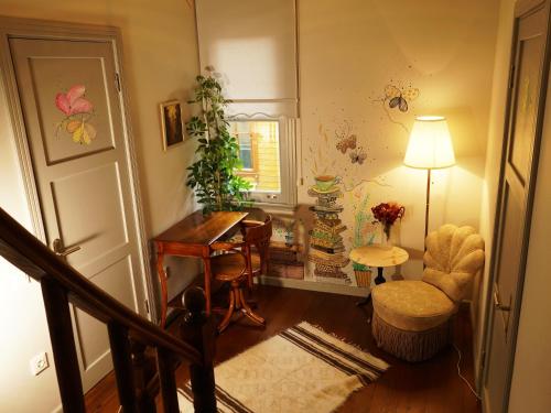 a living room with a table and a chair at Tilas - Rooms in 19th Century Wooden Townhouse,Kadikoy in Istanbul