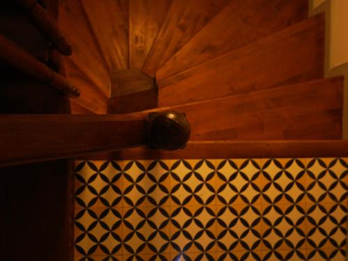 a wooden drawer with a knob on a black and white pattern at Tilas - Rooms in 19th Century Wooden Townhouse,Kadikoy in Istanbul