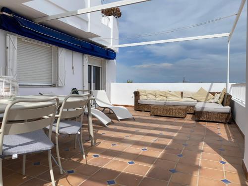 a patio with a table and chairs and a couch at RESIDENCIAL OASIS 3 in Mojácar