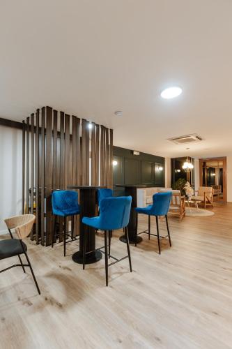 a lobby with blue chairs and a table at 1616 Hotel in Medellín