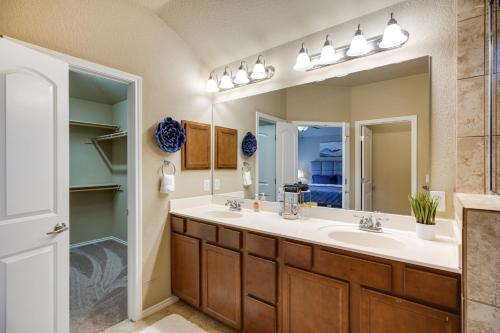 a bathroom with two sinks and a large mirror at San Antonio Vacation Rental with Patio Near SeaWorld in San Antonio