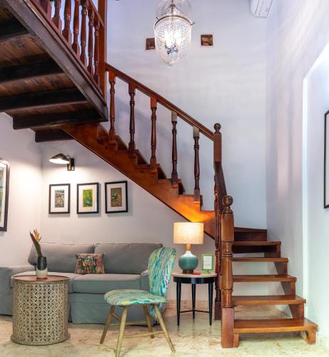 a living room with a couch and a staircase at Casa Sol Bed and Breakfast in San Juan