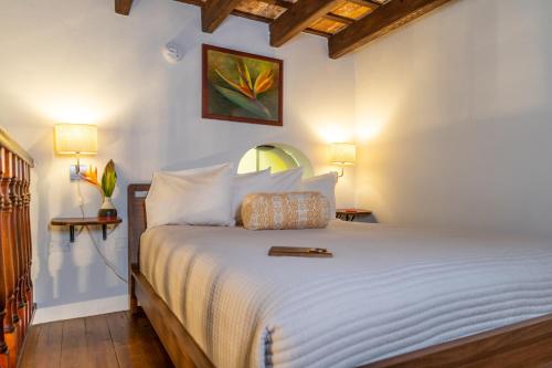 um quarto com uma grande cama branca e 2 candeeiros em Casa Sol Bed and Breakfast em San Juan