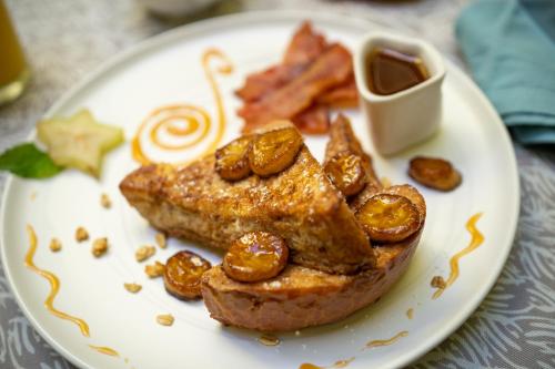 a plate of food with a piece of bread and nuts at Casa Sol Bed and Breakfast in San Juan