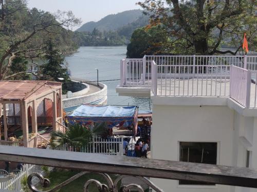 a view of the water from the balcony of a building at The Periwinkle Homestay Bhimtal in Bhīm Tāl