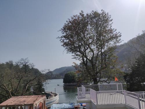a view of a river with a boat in the water at The Periwinkle Homestay Bhimtal in Bhīm Tāl