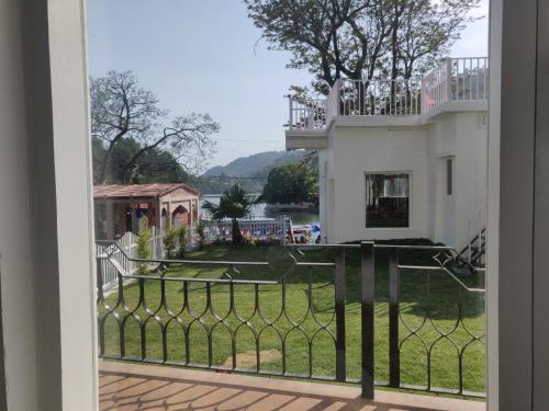 a view from a balcony of a house at The Periwinkle Homestay Bhimtal in Bhīm Tāl