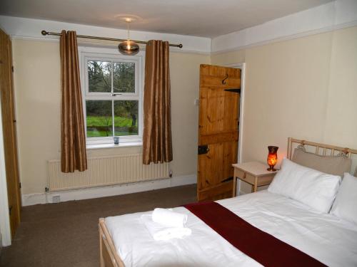 a bedroom with a bed and a window at Heathfield in Taunton