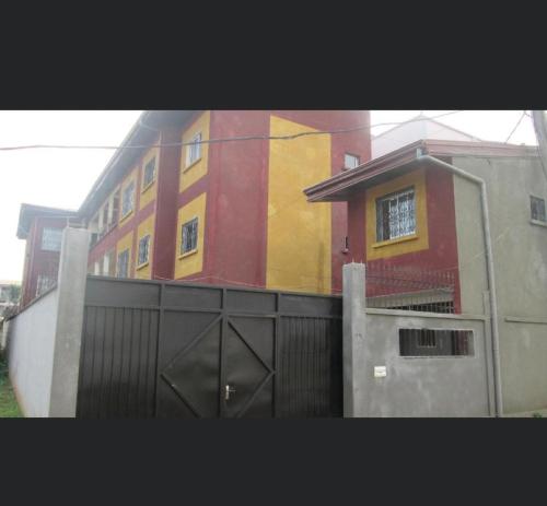 a building with a gate in front of it at Résidence H in Yaoundé