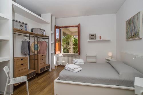 Un dormitorio con una cama y una cómoda y una ventana. en Villa Costanza, en Mondello