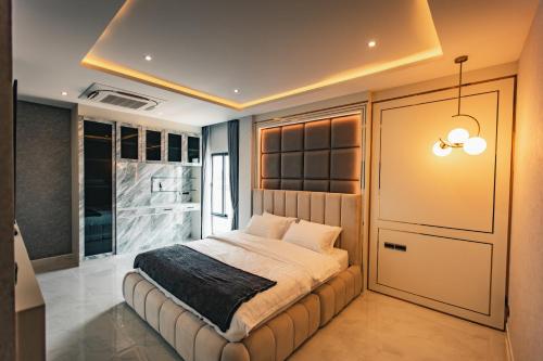 1 dormitorio con 1 cama y puerta corredera en Astro Luxury: Ultra Luxury 4 Beds Pool Villa, en Nong Prue