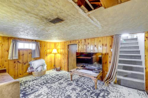 a living room with wood paneled walls and a television at Cozy Helper Home with Fenced Yard, Pets Welcome in Helper