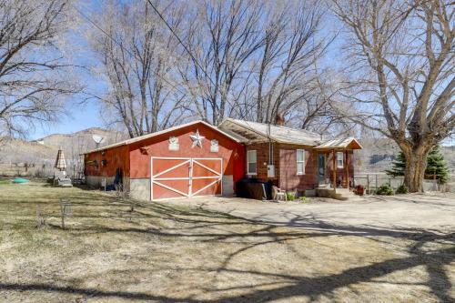 a red barn with a white door in a yard at Cozy Helper Home with Fenced Yard, Pets Welcome in Helper