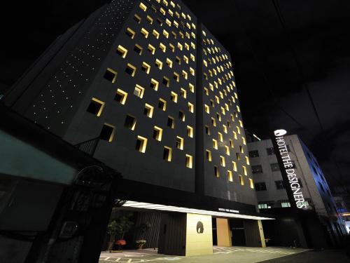a tall building with many windows at night at Hotel The Designers Jongro in Seoul