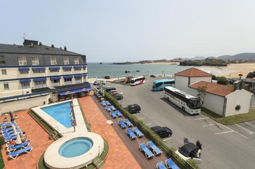 a hotel with a swimming pool next to a beach at Hotel Astuy in Isla