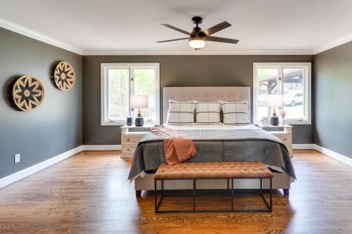 a bedroom with a bed and a ceiling fan at Spacious Waterfront Hyco Lake Retreat with Dock! in Roxboro