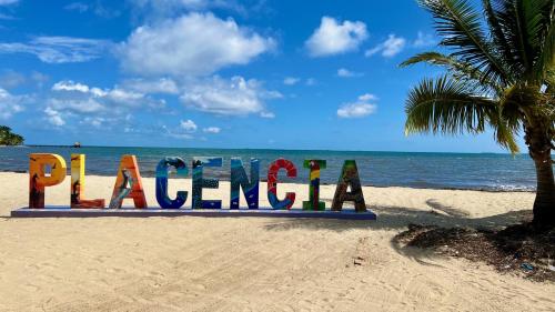 a sign that says fun on the beach at Bella Sway Belize in Maya Beach