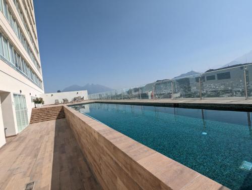 a swimming pool on the side of a building at Stylish Panoramic Views City Loft in Monterrey