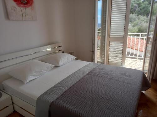 Ένα ή περισσότερα κρεβάτια σε δωμάτιο στο Apartmani Vesna Miliša