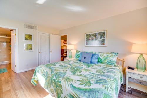 a bedroom with a bed with a tropical bedspread at Hutchinson Island Vacation Rental with Beach Access! in Fort Pierce