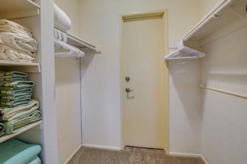 a walk in closet with a white door at Patio, Grill and Pool Access Palm Desert Retreat! in Palm Desert