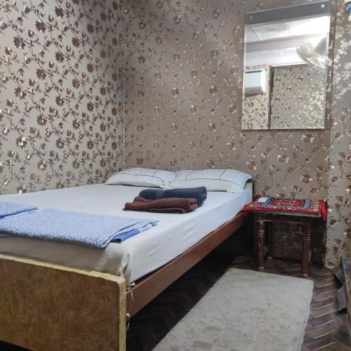 a bed in a room with a mirror and a bed sidx sidx sidx at Ira Homestay Mathura - Divine Spiritual Stay in Mathura