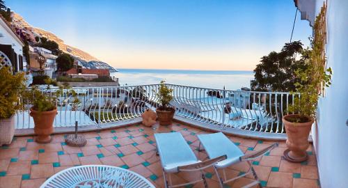 a balcony with chairs and a view of the ocean at Hotel Villa Delle Palme in Positano in Positano