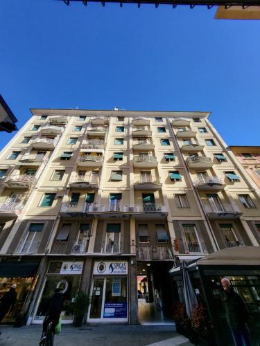 a tall building with balconies and a person on a bike at Greige Apartment in La Spezia