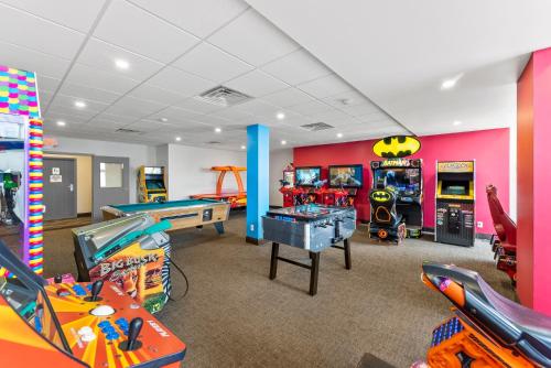 a play room with a bunch of arcade games at Ramada By Wyndham Niagara Falls near the Falls in Niagara Falls