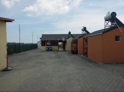 a building with a parking lot next to it at Mara si Marea in Năvodari