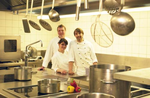 a group of three chefs standing in a kitchen at Hotel - Restaurant Erich Rödiger in Bad Staffelstein