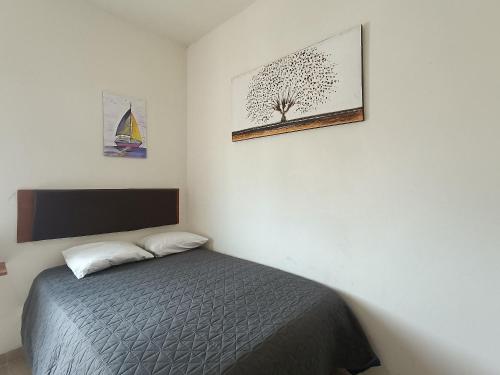 a bedroom with a bed and two pictures on the wall at Condominio Casas Mandala in Costa Esmeralda