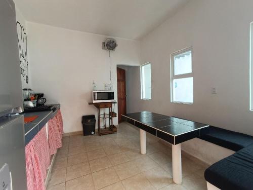 a kitchen with a table in the middle of a room at Condominio Casas Mandala in Costa Esmeralda