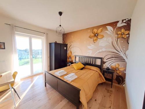 a bedroom with a bed with a flower mural on the wall at Bed & Breakfast La Campagna di Peppe e Tullia in Formia