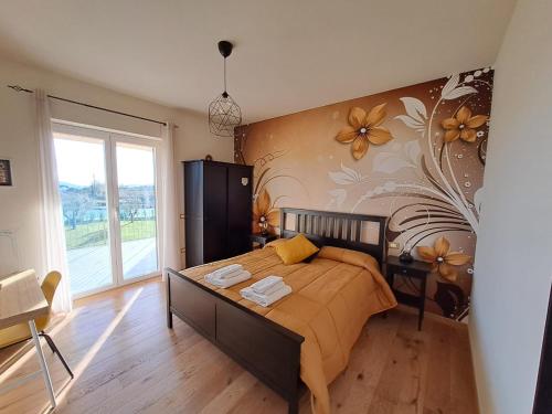 a bedroom with a bed and a flower wall at La Campagna di Peppe e Tullia in Formia