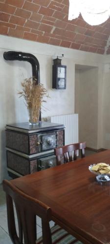 a dining room with a table and a fireplace at La casa dei limoni 