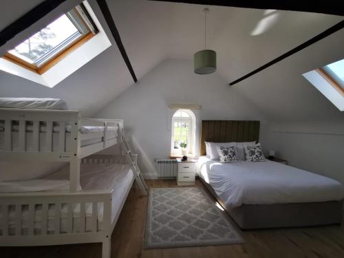 a bedroom with two bunk beds and a window at Knockreagh Farm Cottages, Callan, Kilkenny in Kilkenny