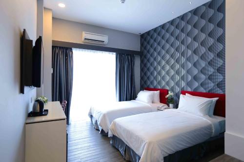 Katil atau katil-katil dalam bilik di Cenang Plaza Beach Hotel